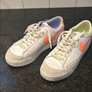 White Sneakers with Orange Swoosh